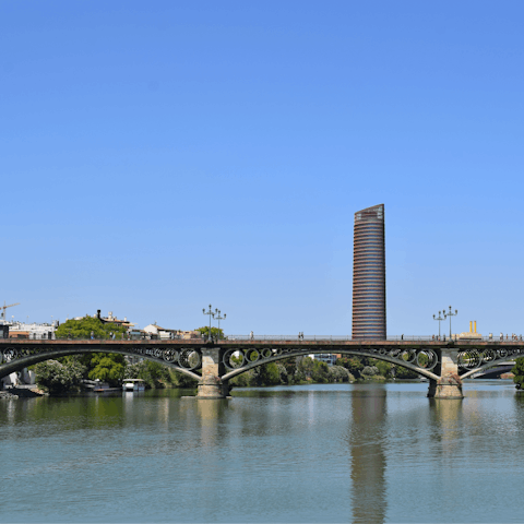 Stroll across the Puente de Triana to visit Seville's historic centre