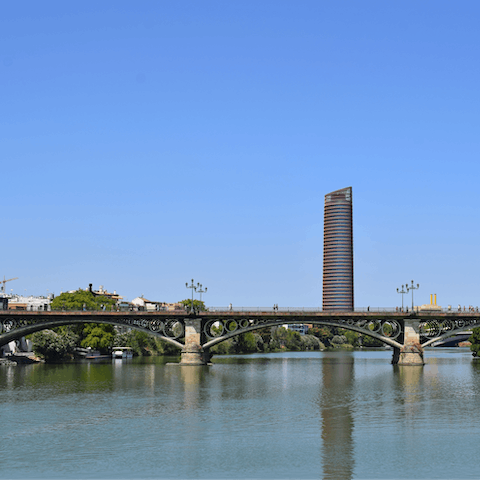 Stroll across the Puente de Triana to visit Seville's historic centre