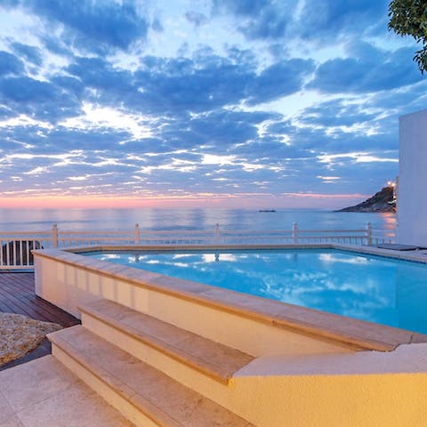 Watch the sunset over the sea from your sparkling private pool