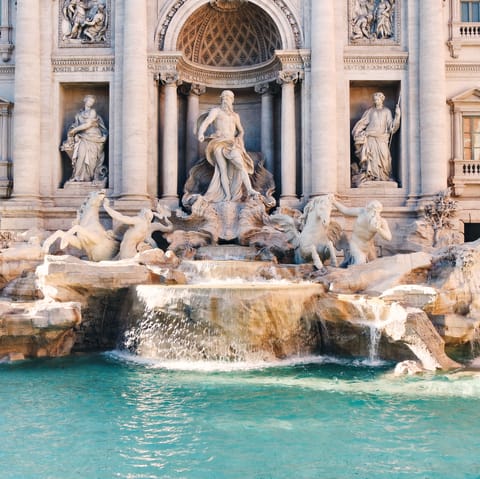 Stroll fifteen minutes through Rome's cobbled streets to the iconic Trevi Fountain
