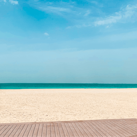 Soak up the sunshine on Jumeirah Beach, a twenty-minute drive away