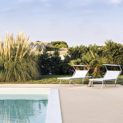 Recline on a poolside sun lounger in the Sicilian sunshine