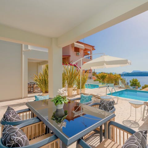 Feast all together around your alfresco dining set while enjoying views of the pool and sea
