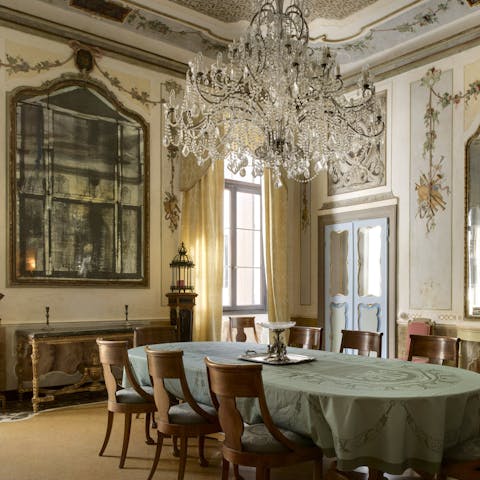 Share meals beneath a Murano glass chandelier