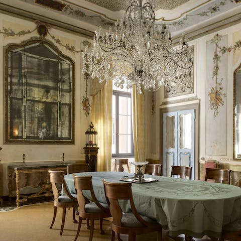 Share meals beneath a Murano glass chandelier