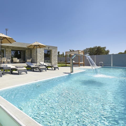 Enjoy sunbathing on a poolside lounger before taking a dip in the outdoor pool