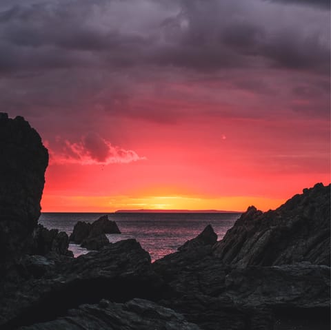 Marvel at scarlet sunsets over Lundy Island from the cliffs at Baggy Point – a ten-minute drive away