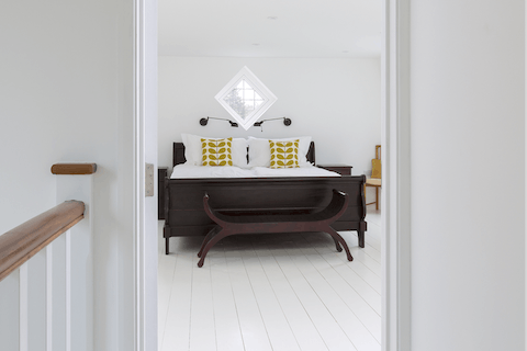 The contrasting dark wood bed frame