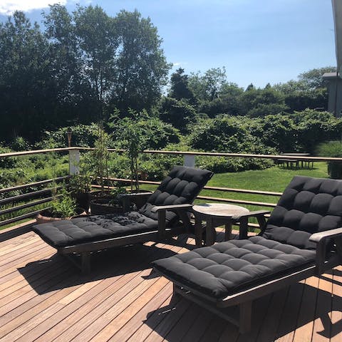 Relax on the decking surrounded by greenery