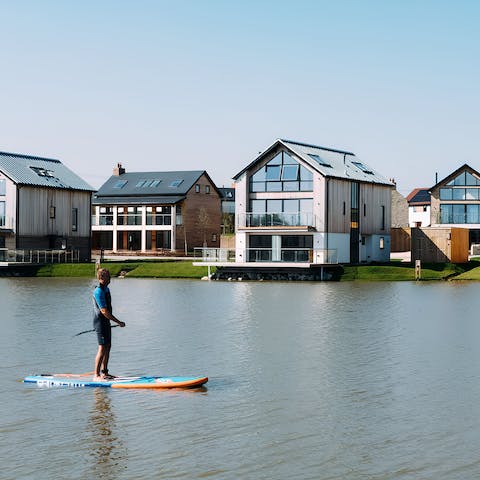 Hire out paddle boards from the activity hub to explore the lakes