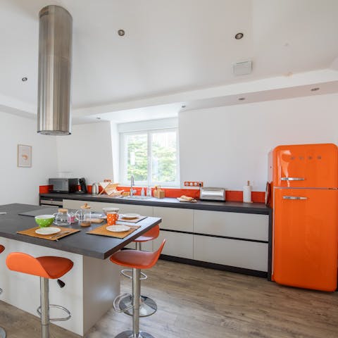 Whip up a breakfast for everyone in the morning in the vibrant and modern kitchen