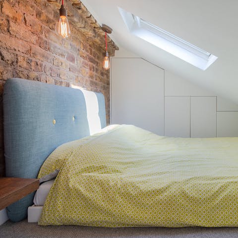 Fall asleep to the glow of the moon in the industrial-style mezzanine bedroom