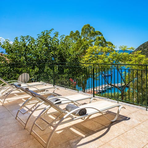 Lie up on a lounger and admire the view of the bay below