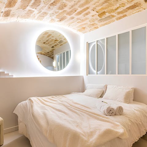 Return to a warm and inviting bedroom after a night out in Paris