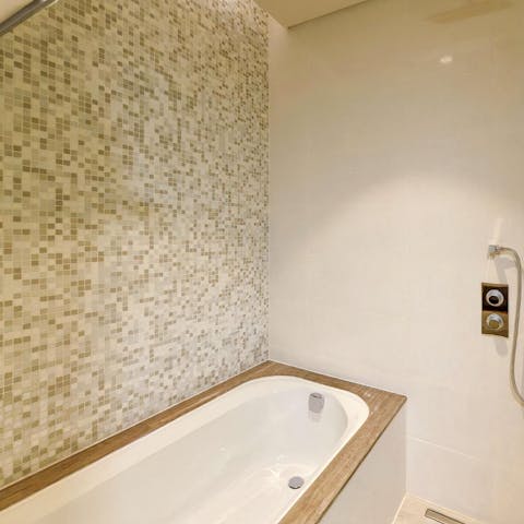 Treat yourself to a rejuvenating soak in the mosaiced bathroom