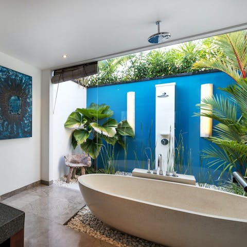Bathe in the partially open-air en-suite bathrooms of this tropical home