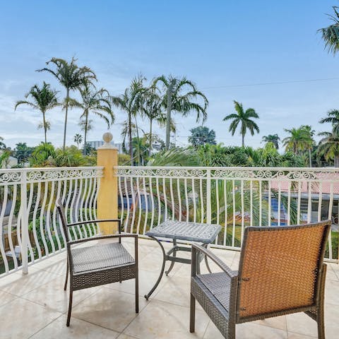 Enjoy your morning coffee on the balcony, overlooking swaying palm trees 
