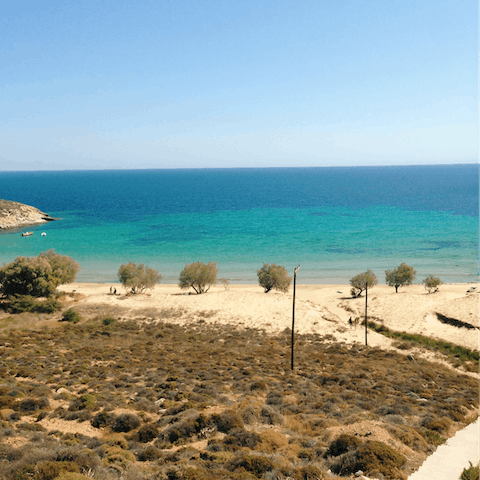 Take a dip in the crystal clear waters at Psarou Beach