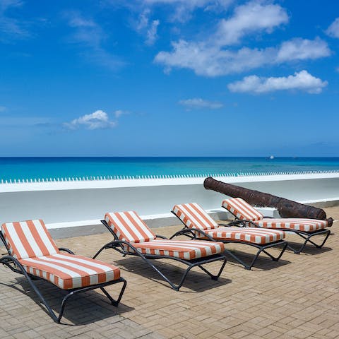 Take in the panoramic sea views from the sun terrace – the beach is just on the other side of your wall