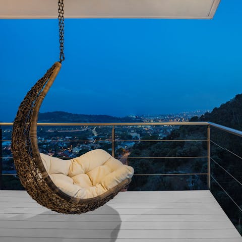 Watch the sun set from the hanging chair on the balcony