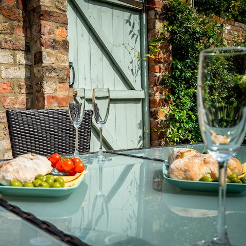Dine outside and enjoy the privacy of ivy-dappled walls
