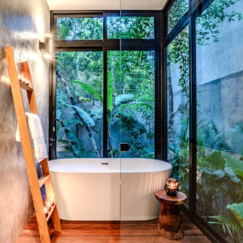 Look out into the jungle from the peaceful bathtub 