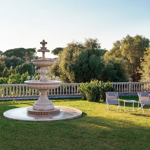 Peruse the beautifully-manicured gardens and furnished terraces around the villa