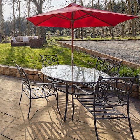 Tuck into tasty English fare alfresco on your patio dining set