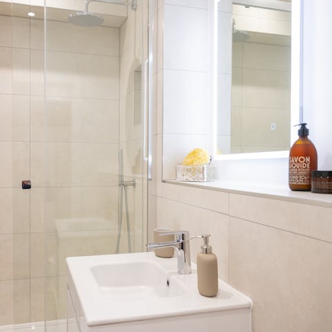 Preen and pamper yourself in the sleek bathroom
