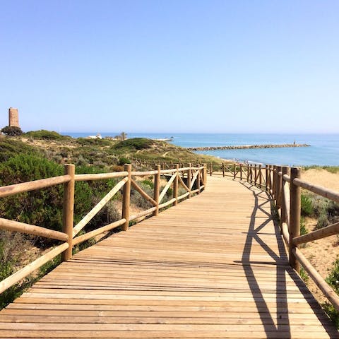 Wander down the wooden walkway through the dunes to Cabopino Beach – only a short walk away