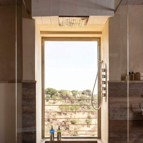 Feel anew beneath the rainfall shower overlooking the Sicilian countryside