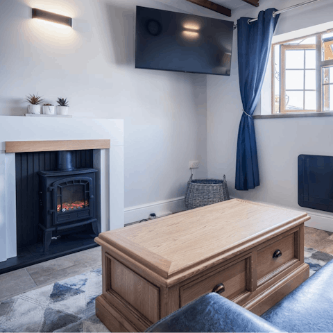 Curl up by the living room's fire for a cosy evening