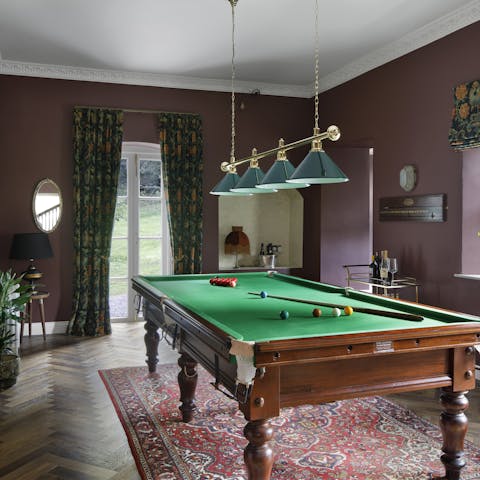 Play a game of pool in the billiards room