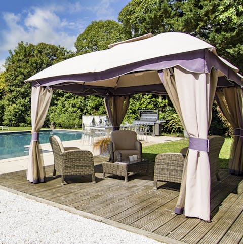 Relax on the shaded terrace with a glass of local Dordogne wine