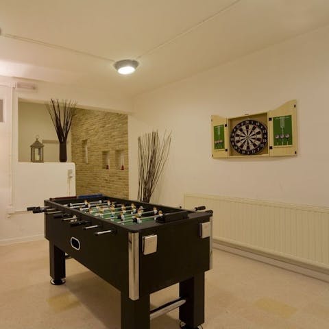Keep entertained with table football and darts in the games room