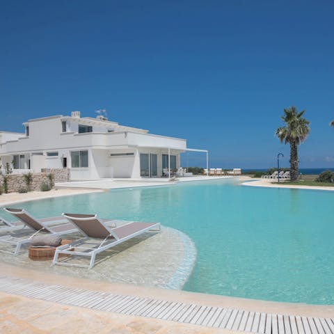 Lounge beside the pool and enjoy sea views