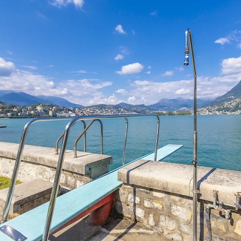 Jump into Lake Lugano from the diving board just across the street from your home