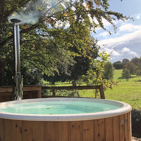 Take in the idyllic countryside from the wood-fired hot tub