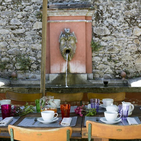 Admire the water feature while you tuck into an alfresco feast