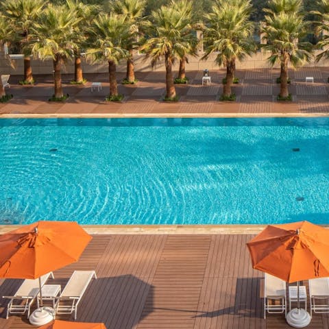 Lounge in the sun by the communal pool or take a dip in its glistening water 