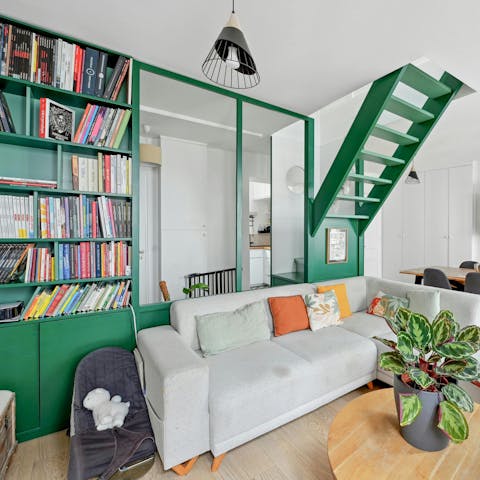 Flip through a guidebook in the vibrant-hued living space