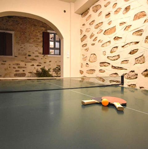 Set up a game of table tennis in the covered games area