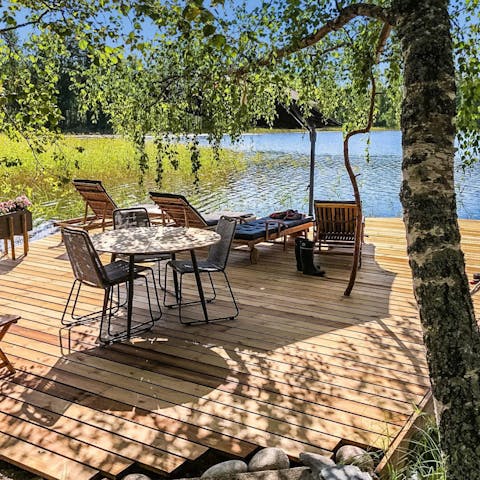 Relax on the pier jutting out into Lake Saimaa and take the rowboat for a little paddle