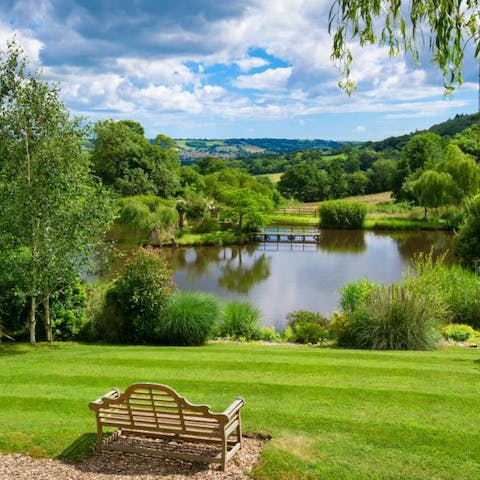 Sit on the bench  by the lake after a stroll through the shared grounds