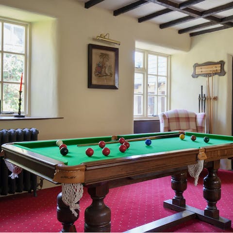 Play a few games of billiards in the games room