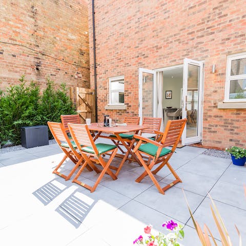 Serve alfresco suppers out on the home's cute patio area