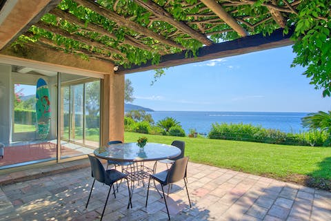 Dine alfresco under the vine-covered pergola as you soak up the sea views