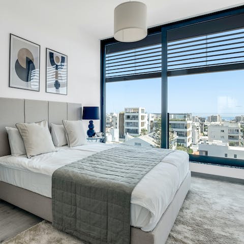 Catch a glimpse of the sea through the bedroom's floor-to-ceiling windows