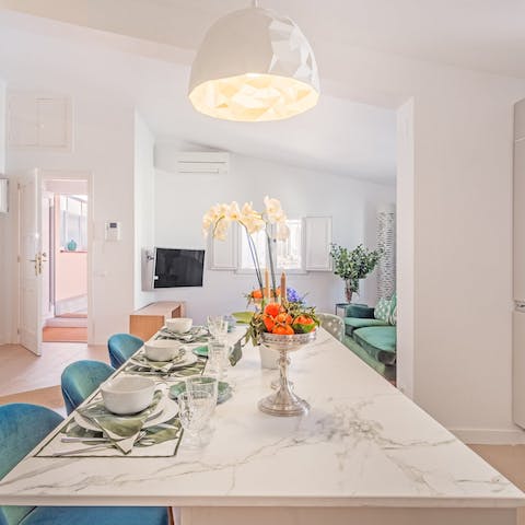 Gather together for meals at the marble kitchen island