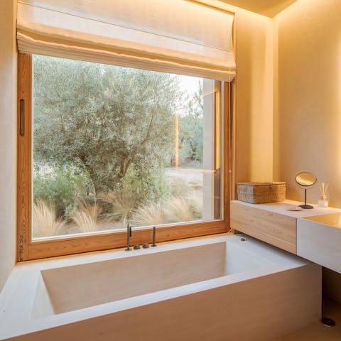 Gaze out at the peaceful gardens from the comfort of the boxy bathtub